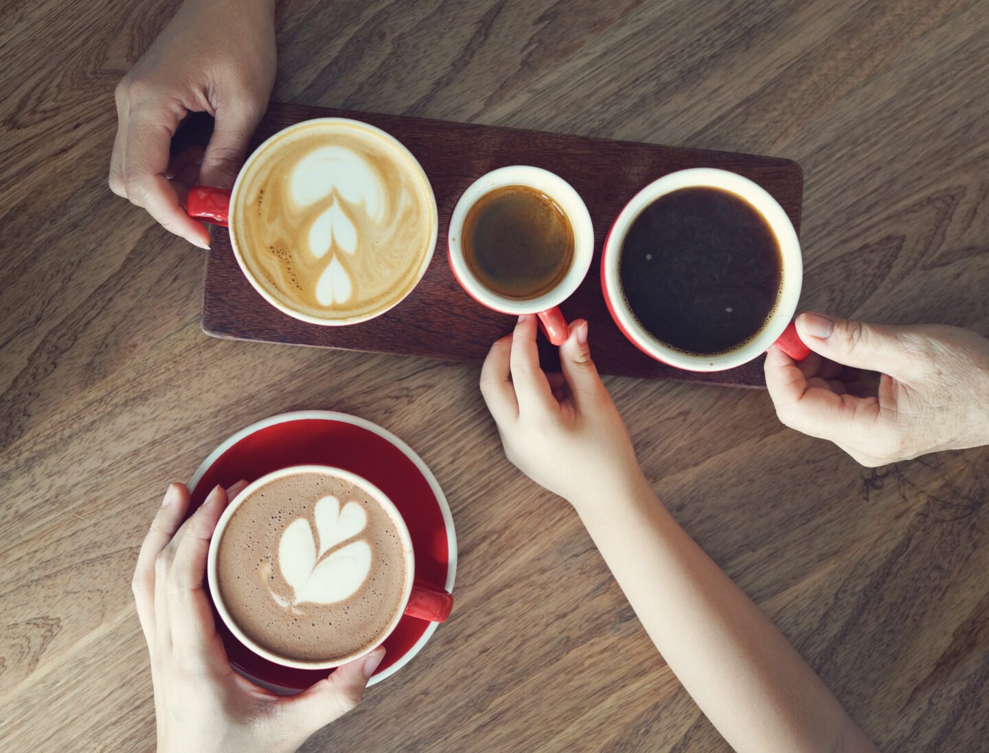 adult-and-kids-hands-taking-coffee