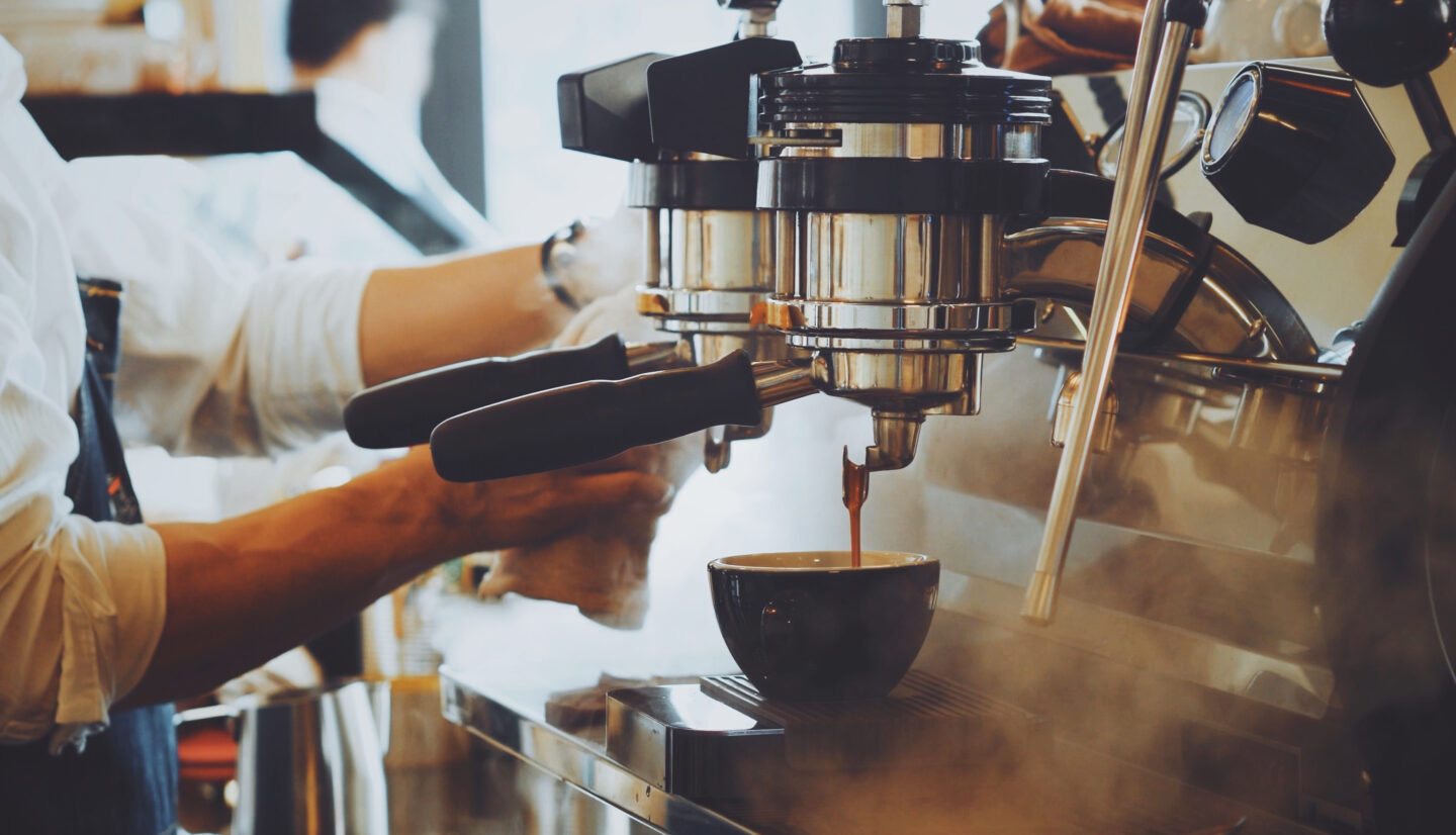 barista-making-latte-art-while-using-espresso-machine