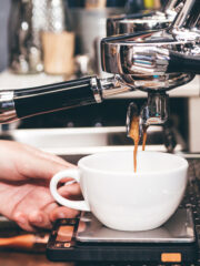 barista-using-a-coffee-machine-to-make-coffee
