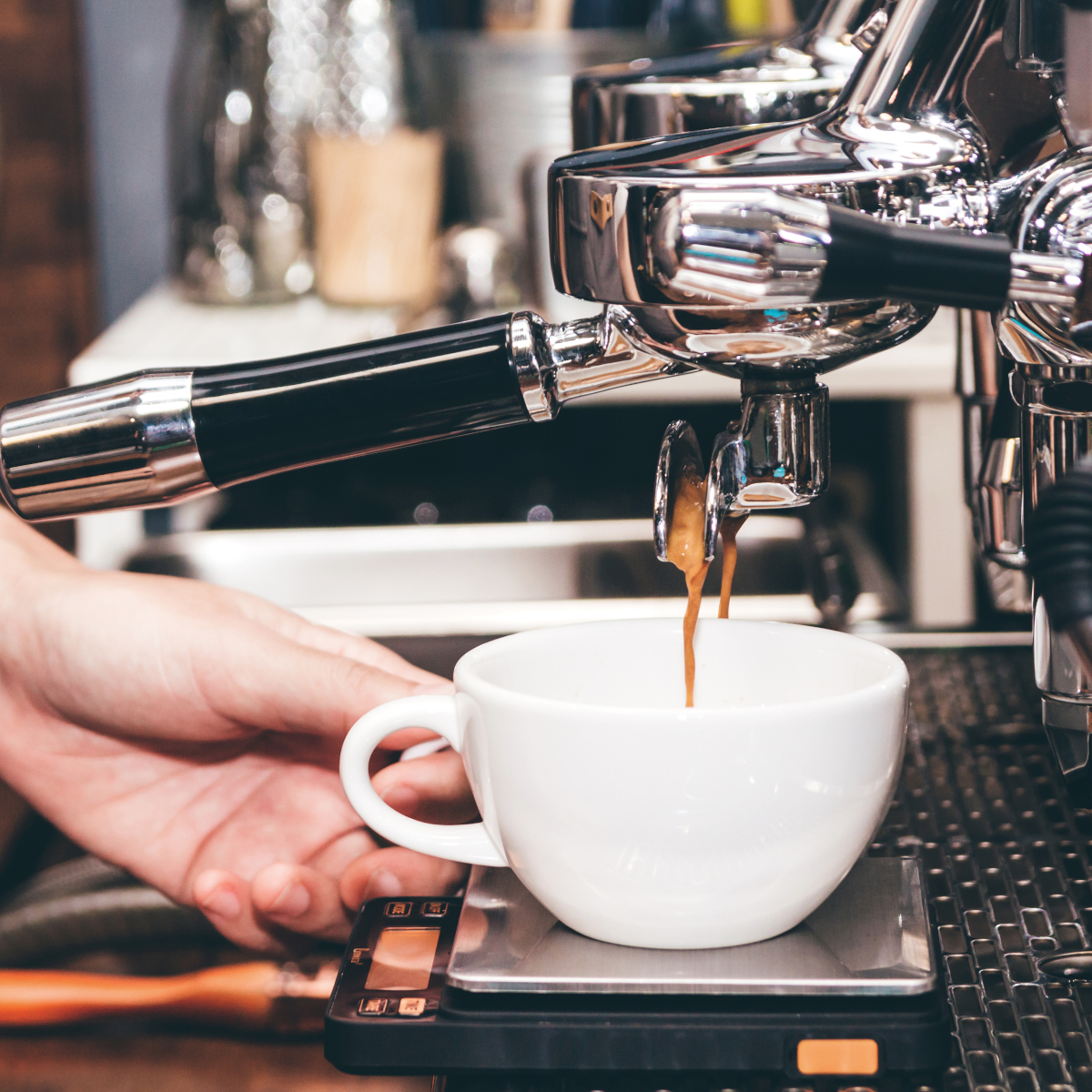barista-using-a-coffee-machine-to-make-coffee