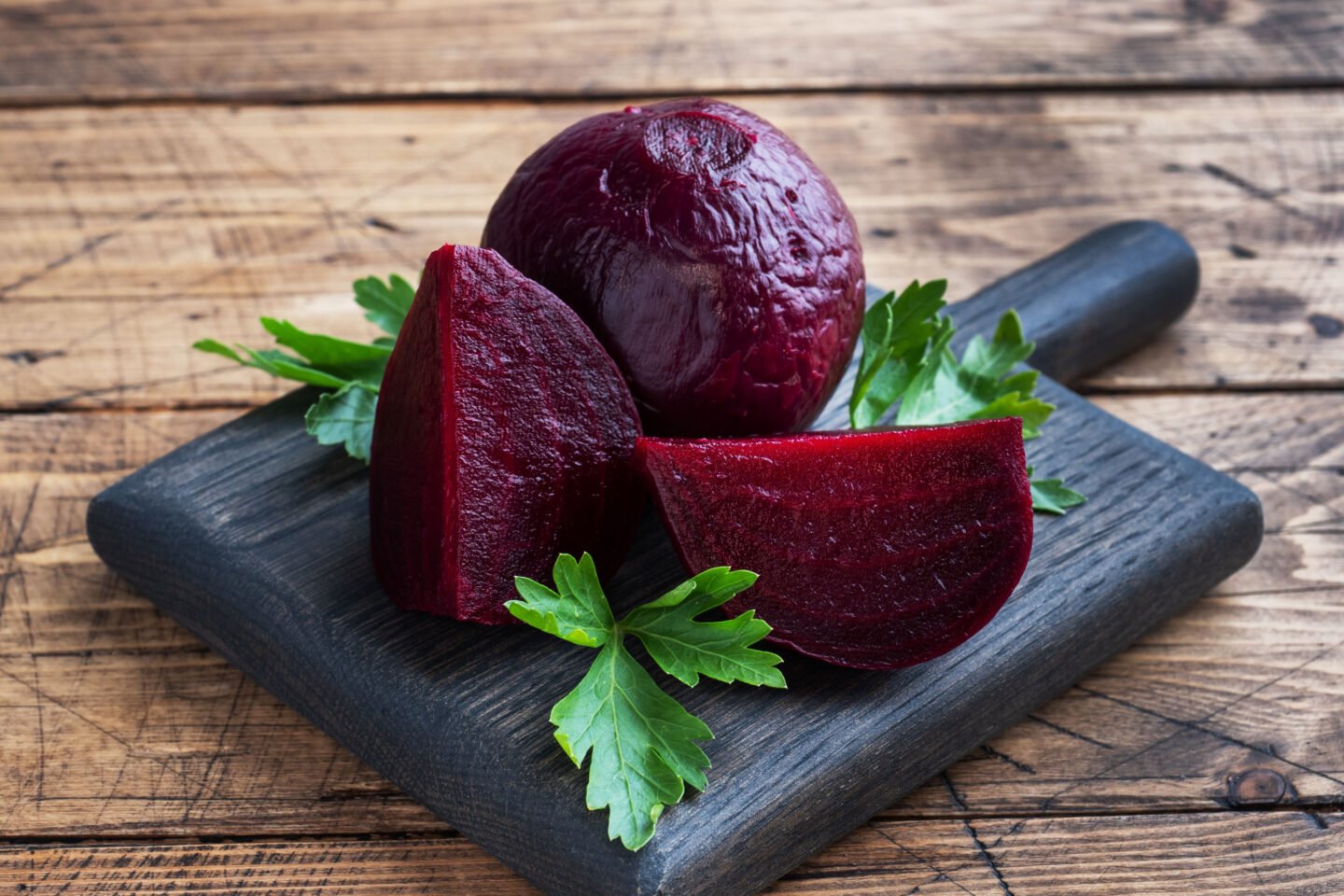 boiled beets on a black wooden board