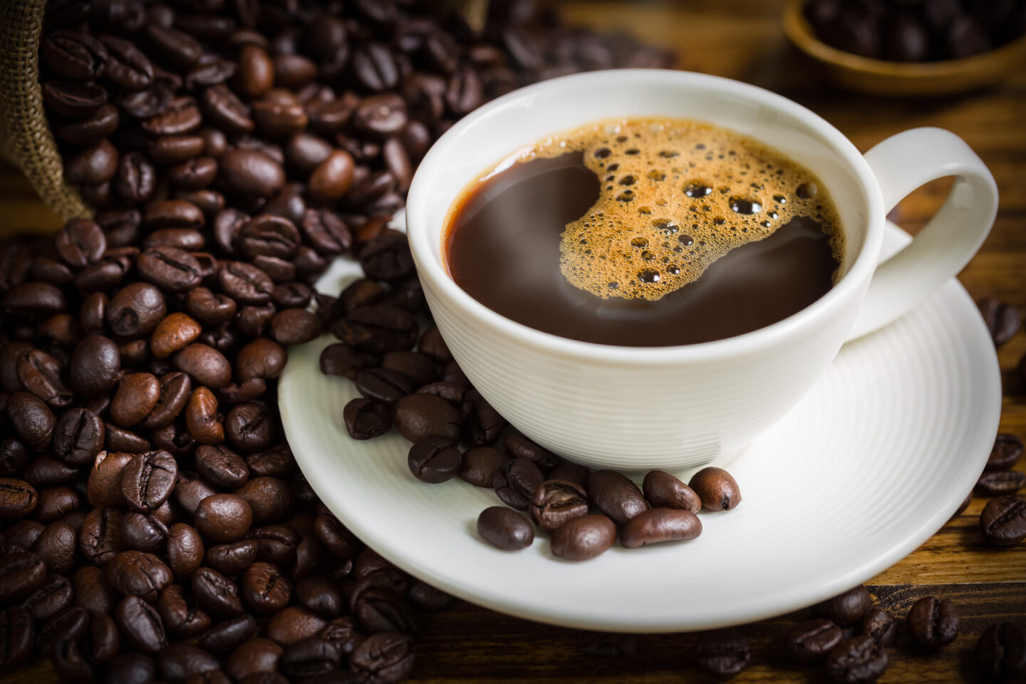 coffee-cup-and-beans-on-wooden-table