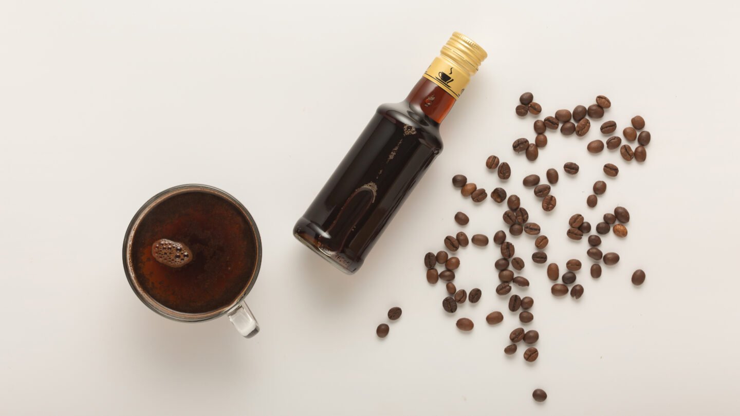 coffee-in-cup-coffee-beans-and-irish-cream-syrup-isolated-on-white-background