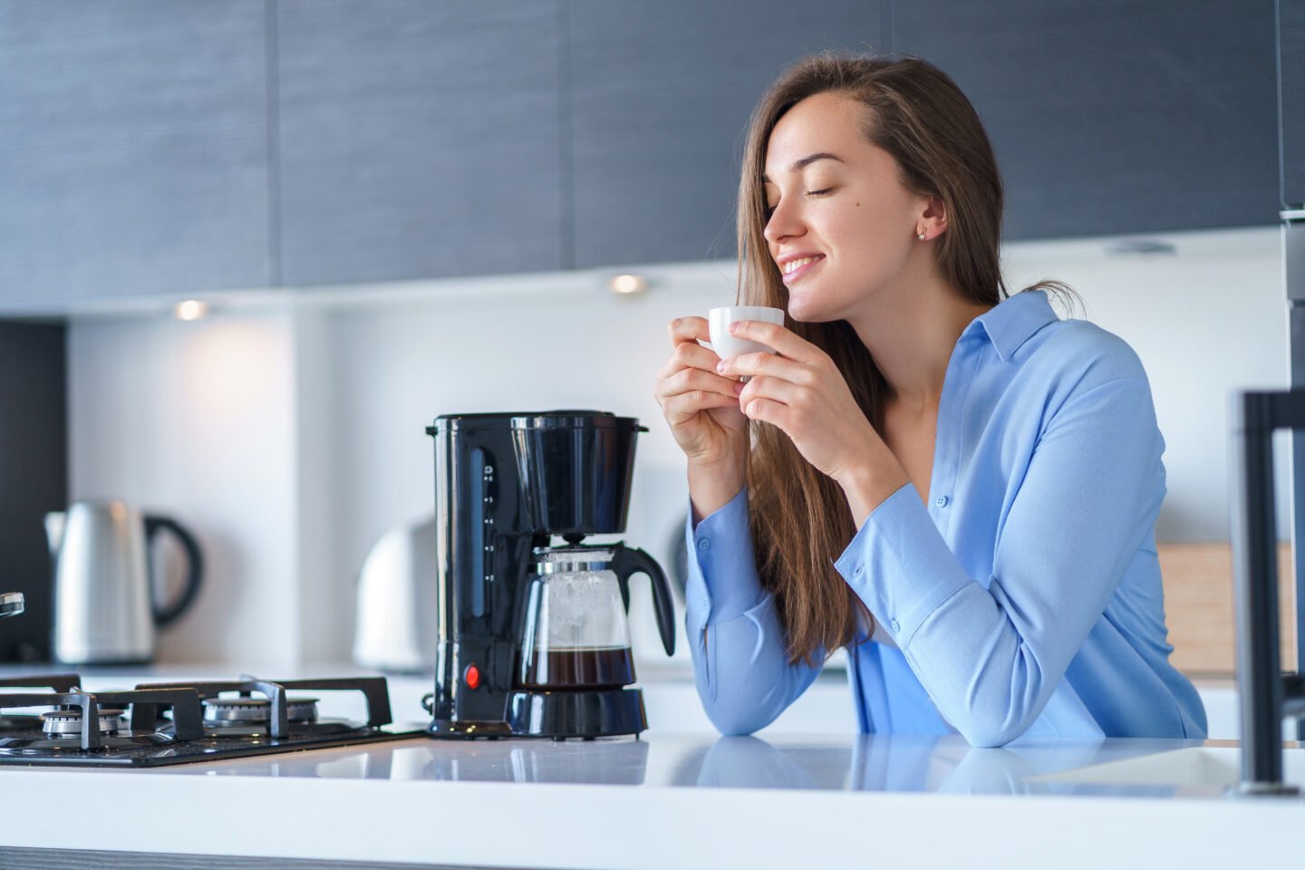 female-enjoying-fresh-coffee-after-brewing-using-coffee-maker