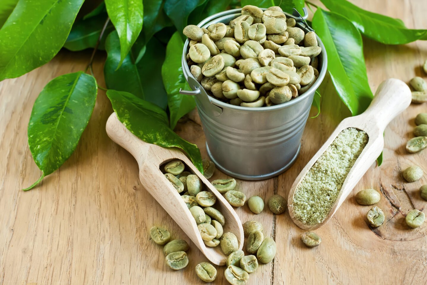 green-coffee-beans-on-a-small-pail-and-wooden-spoons