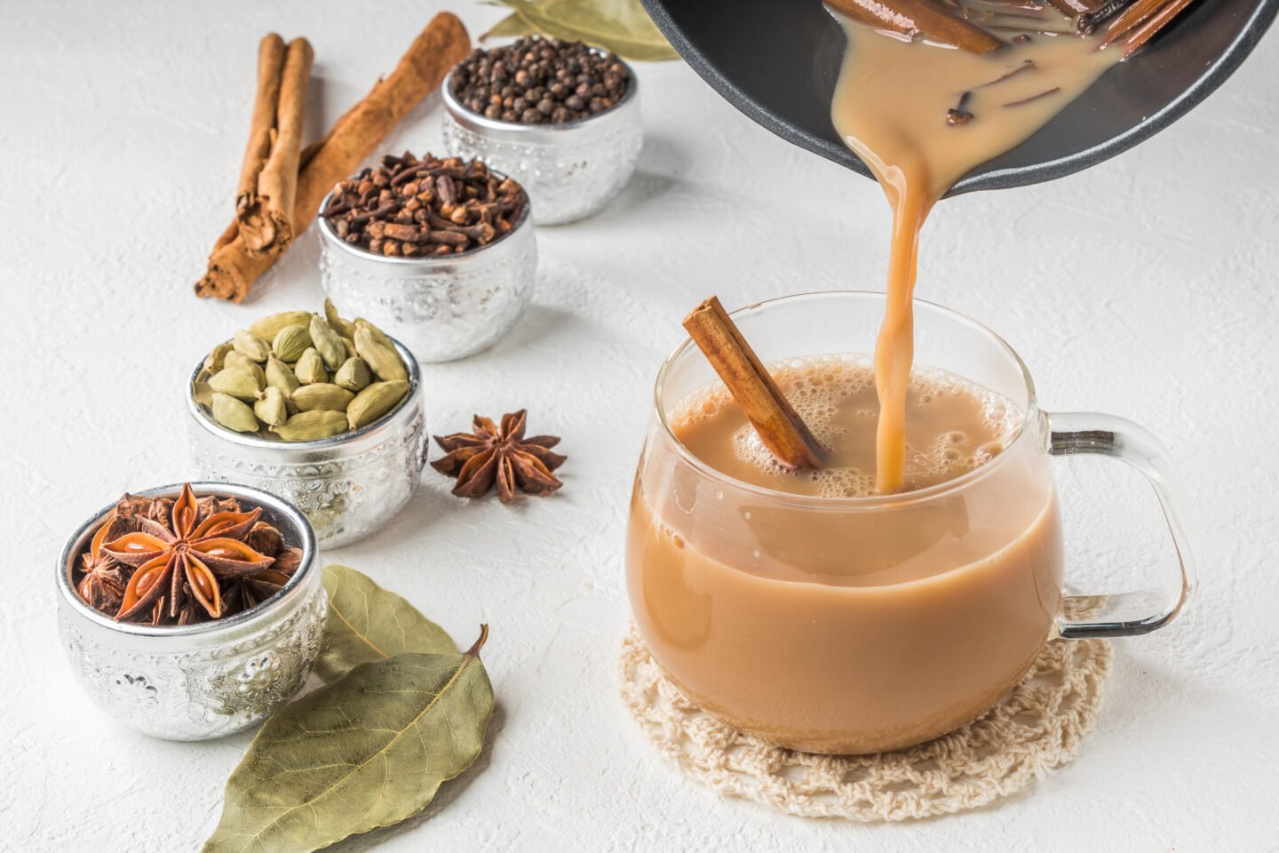 herbal-chai-tea-being-poured-into-a-clear-mug