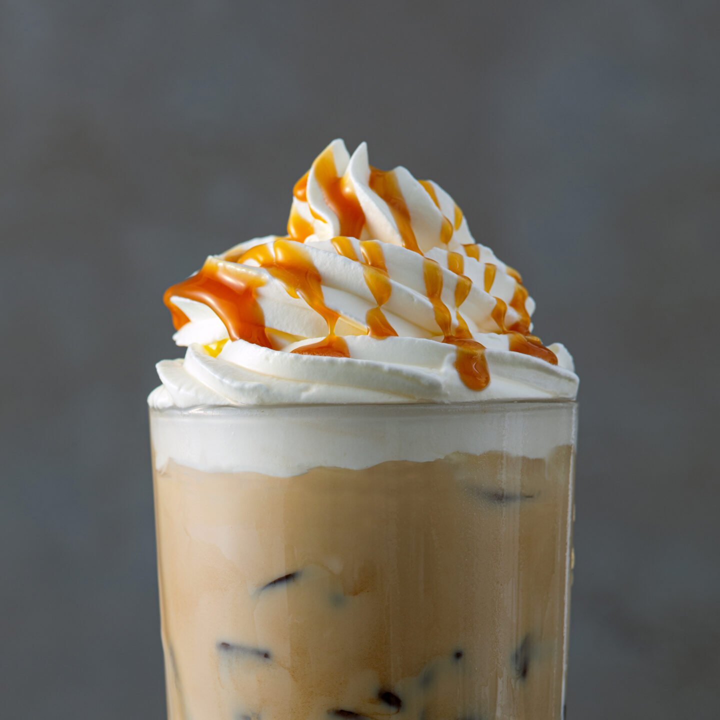 iced-coffee-latte-decorated-with-whipped-cream-and-caramel-sauce