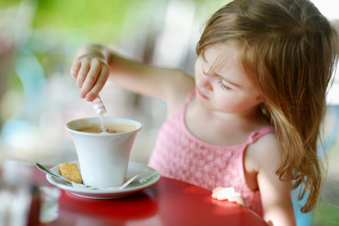 kid-adding-milk-to-her-coffee