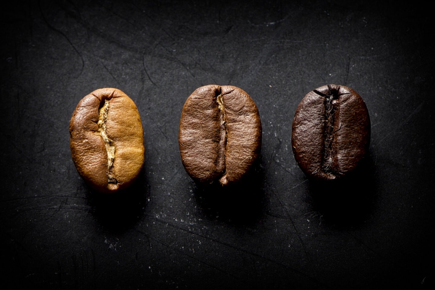 3,Coffee,Beans,Of,Different,Toast,In,A,Black,Background