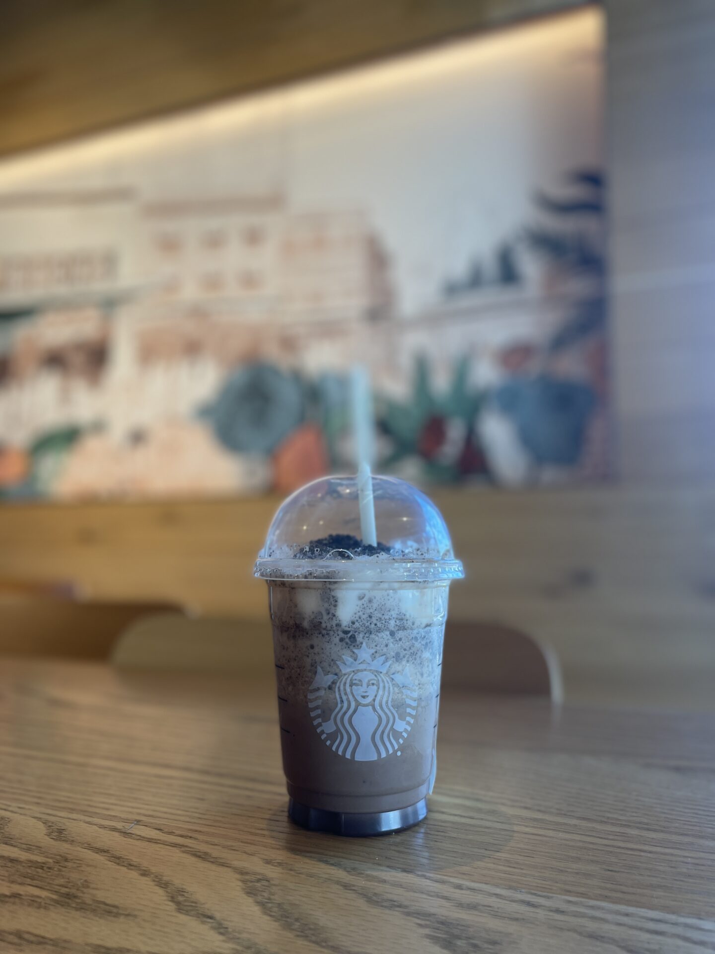 marble frappe with straw on a wooden table
