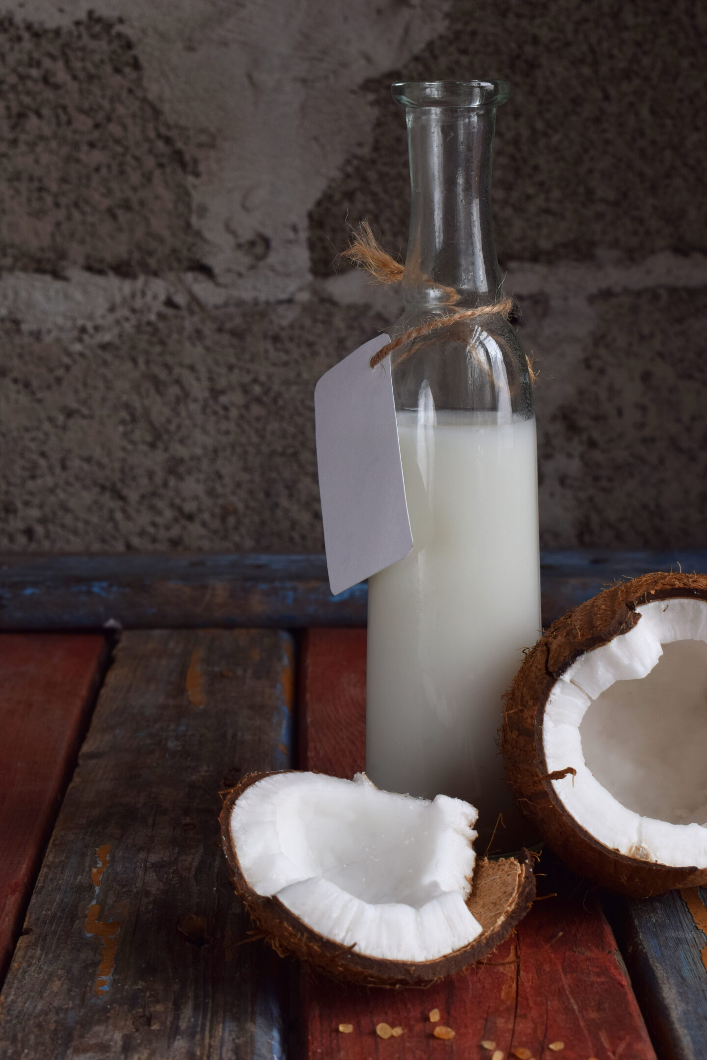 Coconut,Syrup,In,Bottle,With,Broken,Coco,On,Wooden,Background.