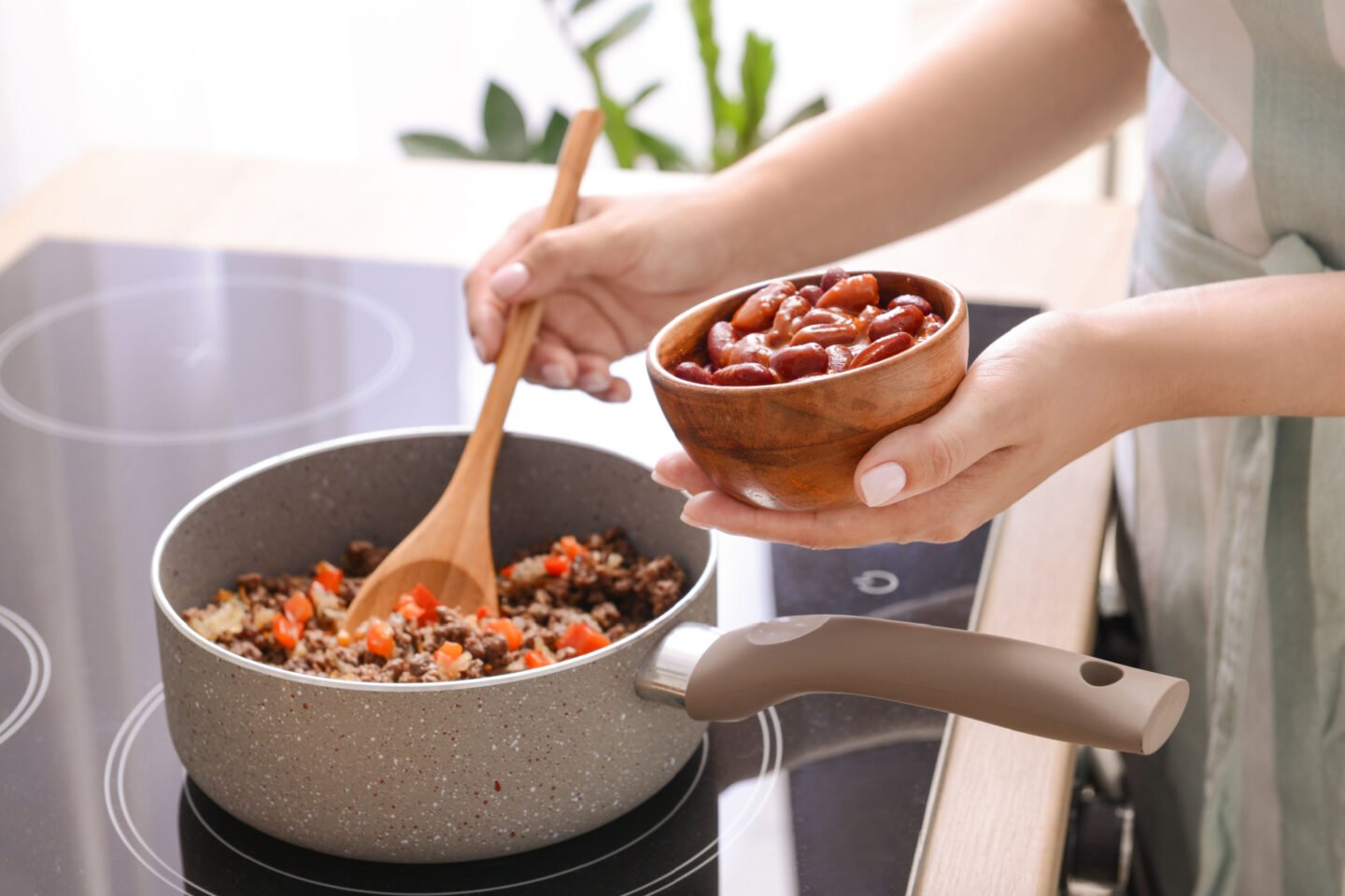 woman cooks chili con carne