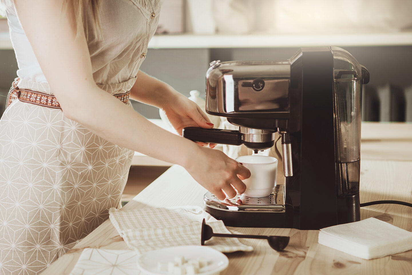 woman-making-fresh-coffee-using-a-coffee-machine