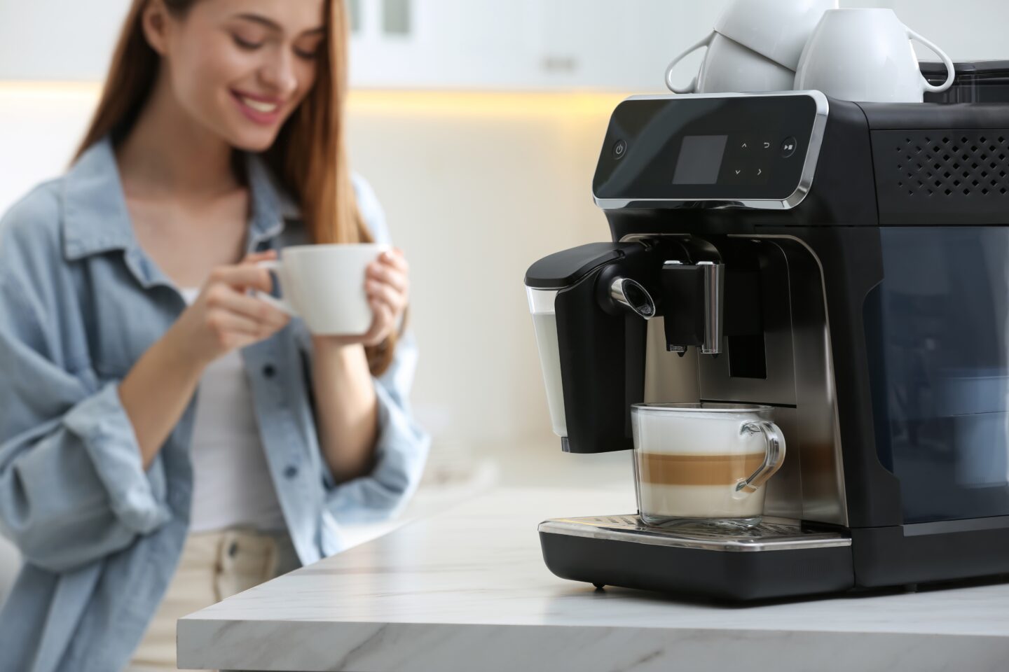 young-woman-enjoying-coffee-from-a-coffee-machine