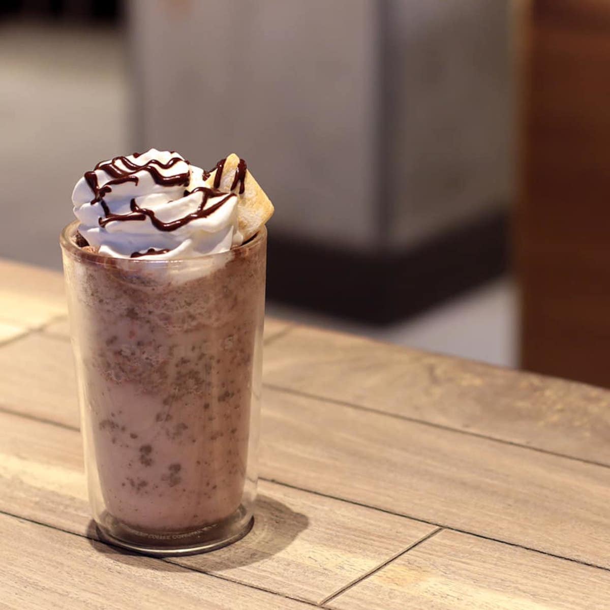 a glass of starbucks drink on a wooden table