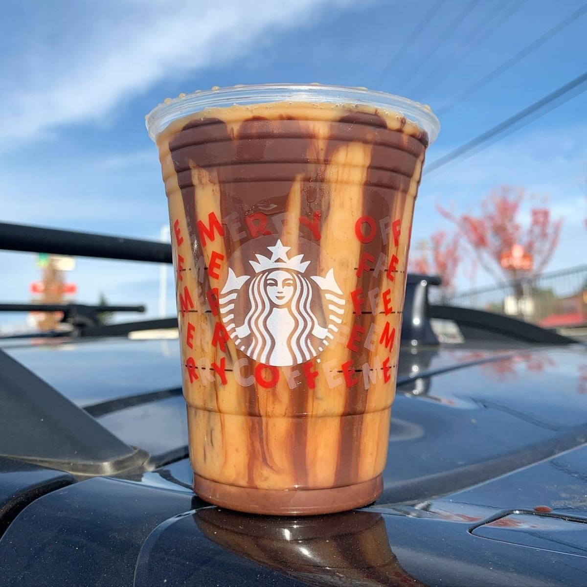 cup of starbucks iced peppermint mocha on car dashboard
