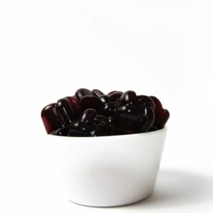 dark red gummies in a cup