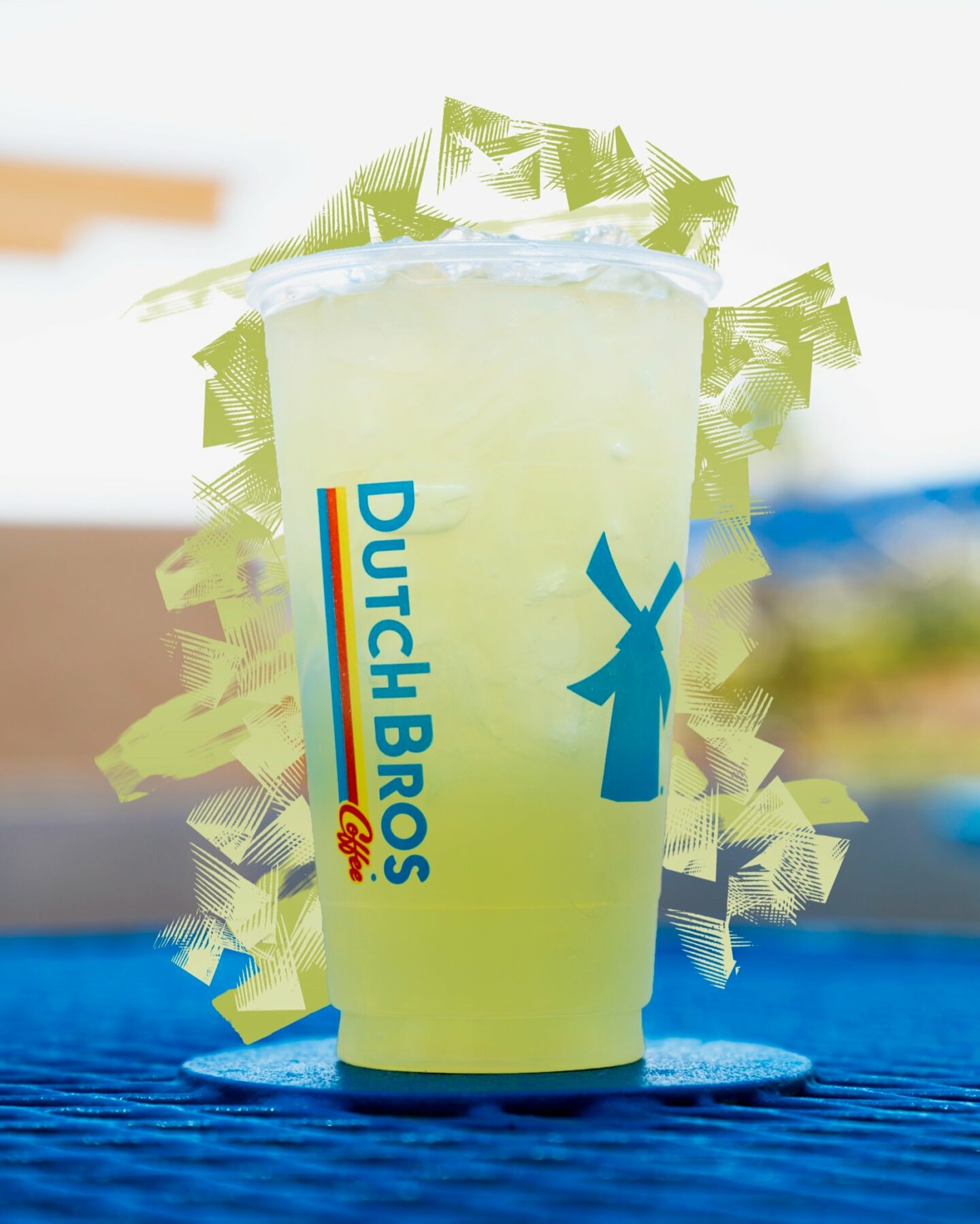 dutch bros iced green tea on blue saucer