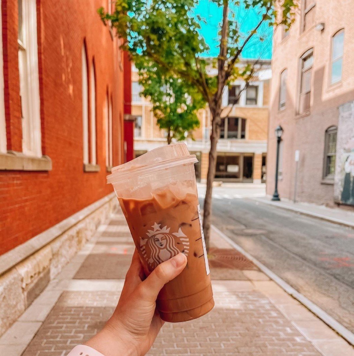 hand tilting cup of peppermint mocha cold brew