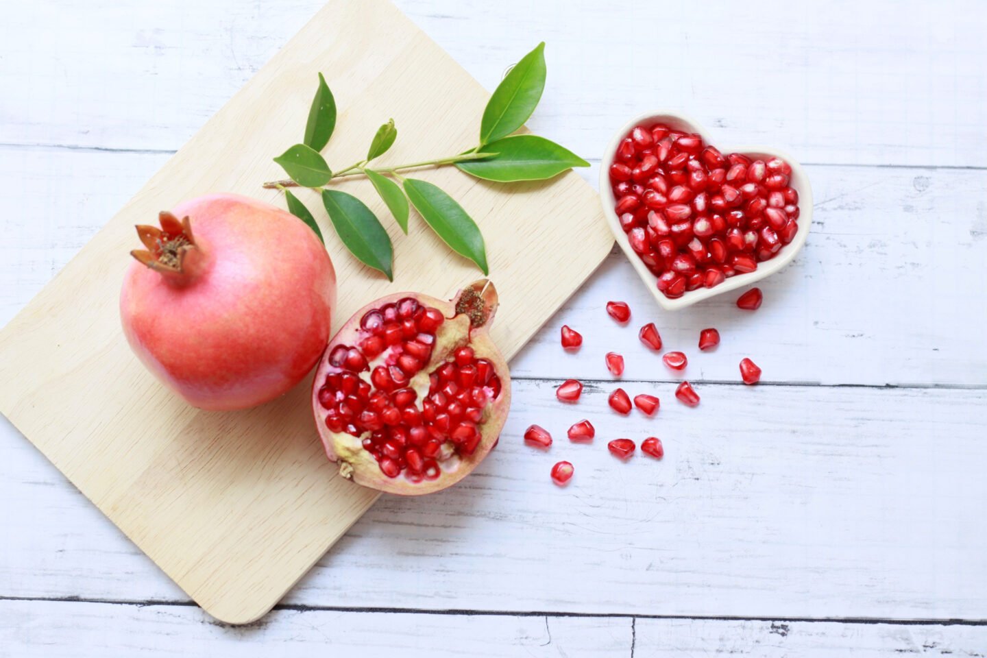 pomegranates whole and half with seeds