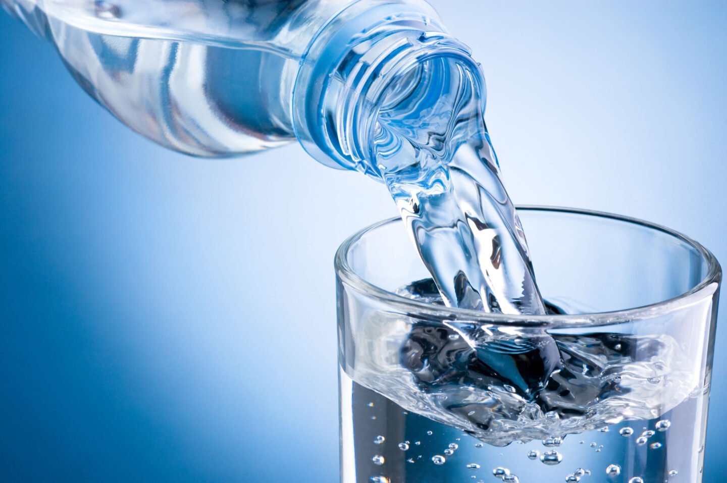 pouring mineralized water from a bottle