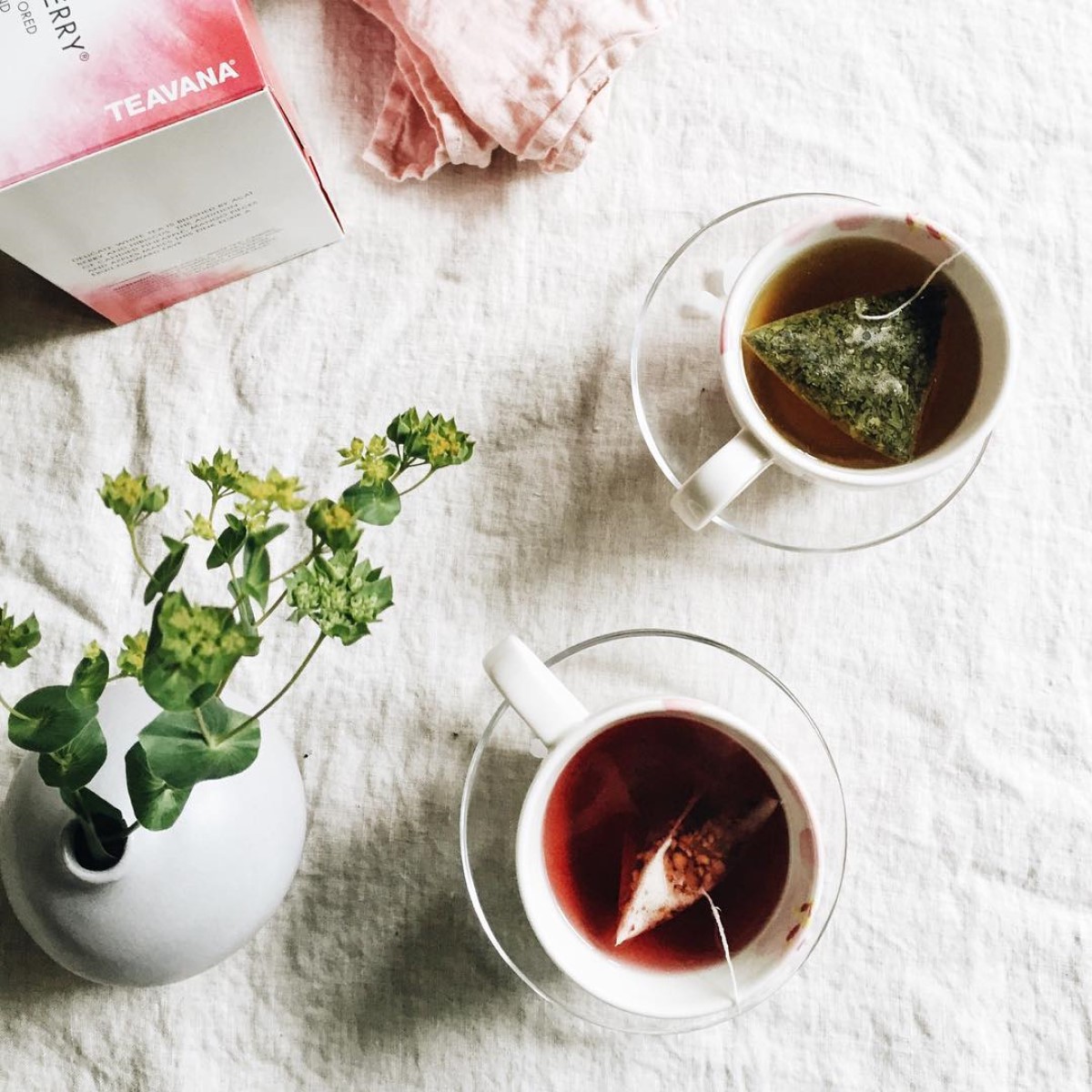 two cups of freshly steeped starbucks mint majesty tea and youthberry tea near each other