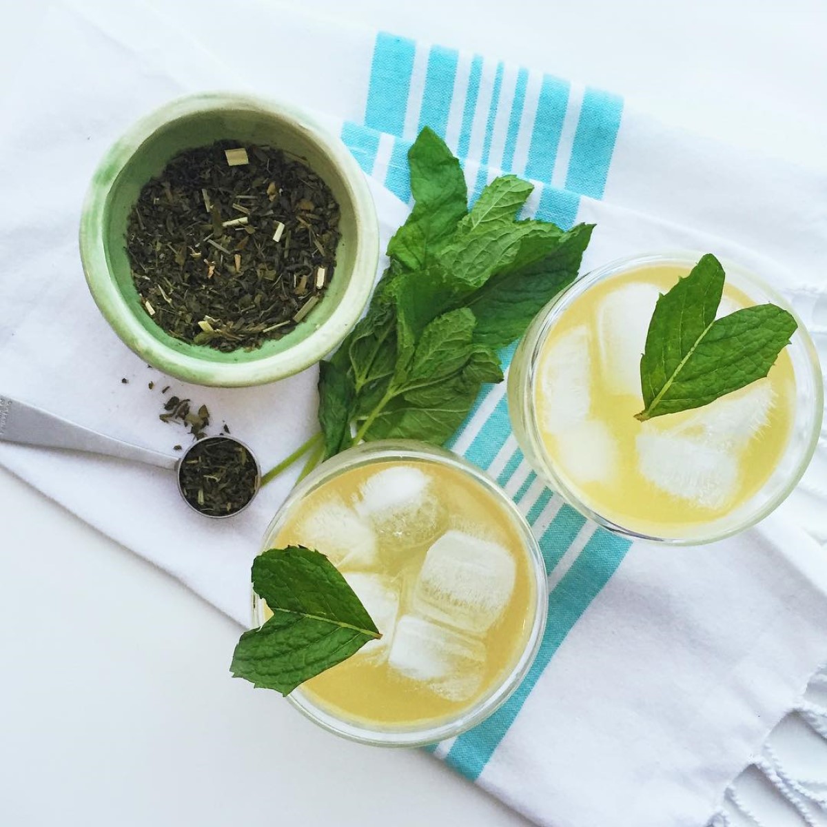 two cups of iced jade citrus mint tea on cloth