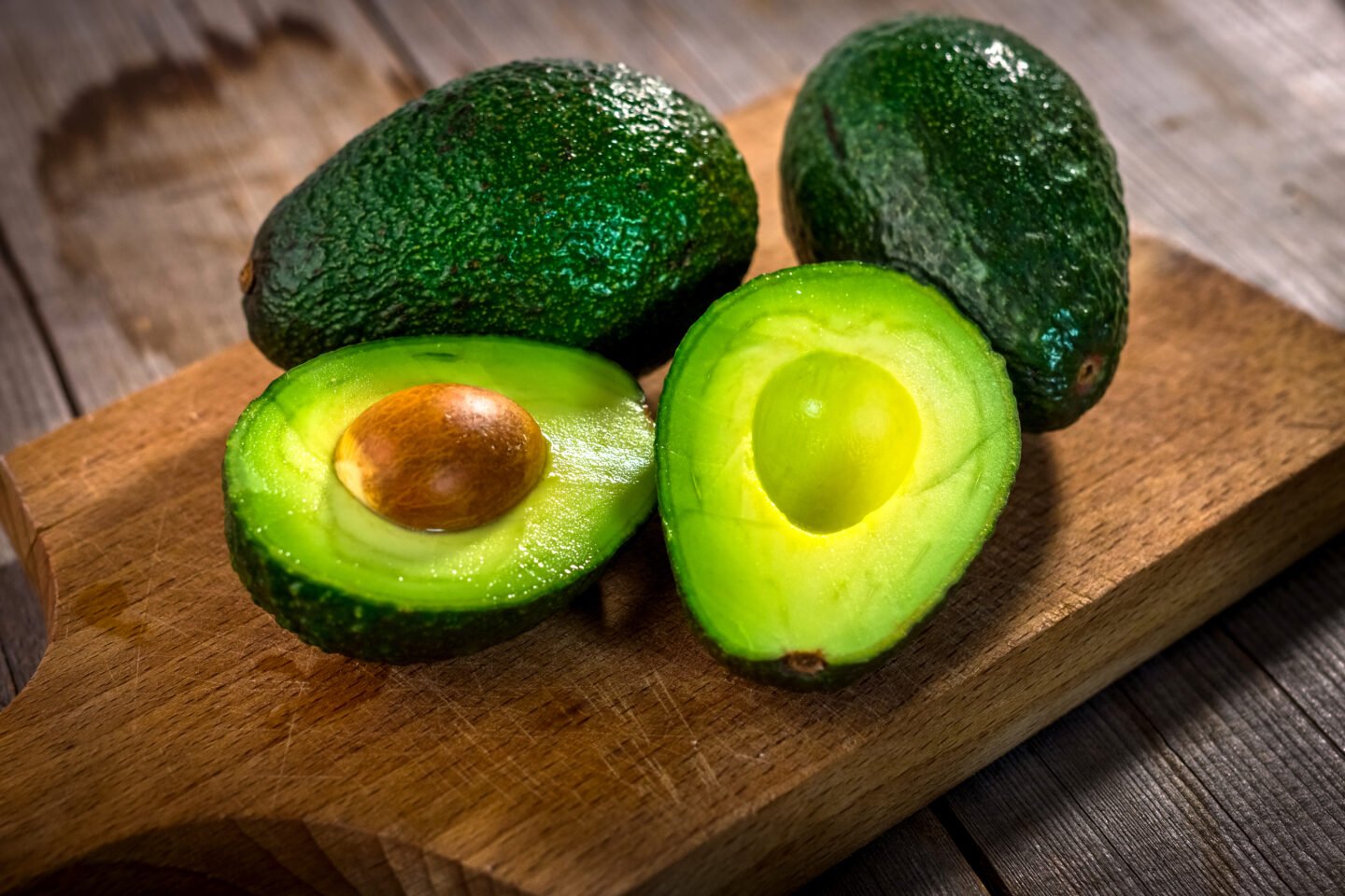 Avocados on  wooden cutting board