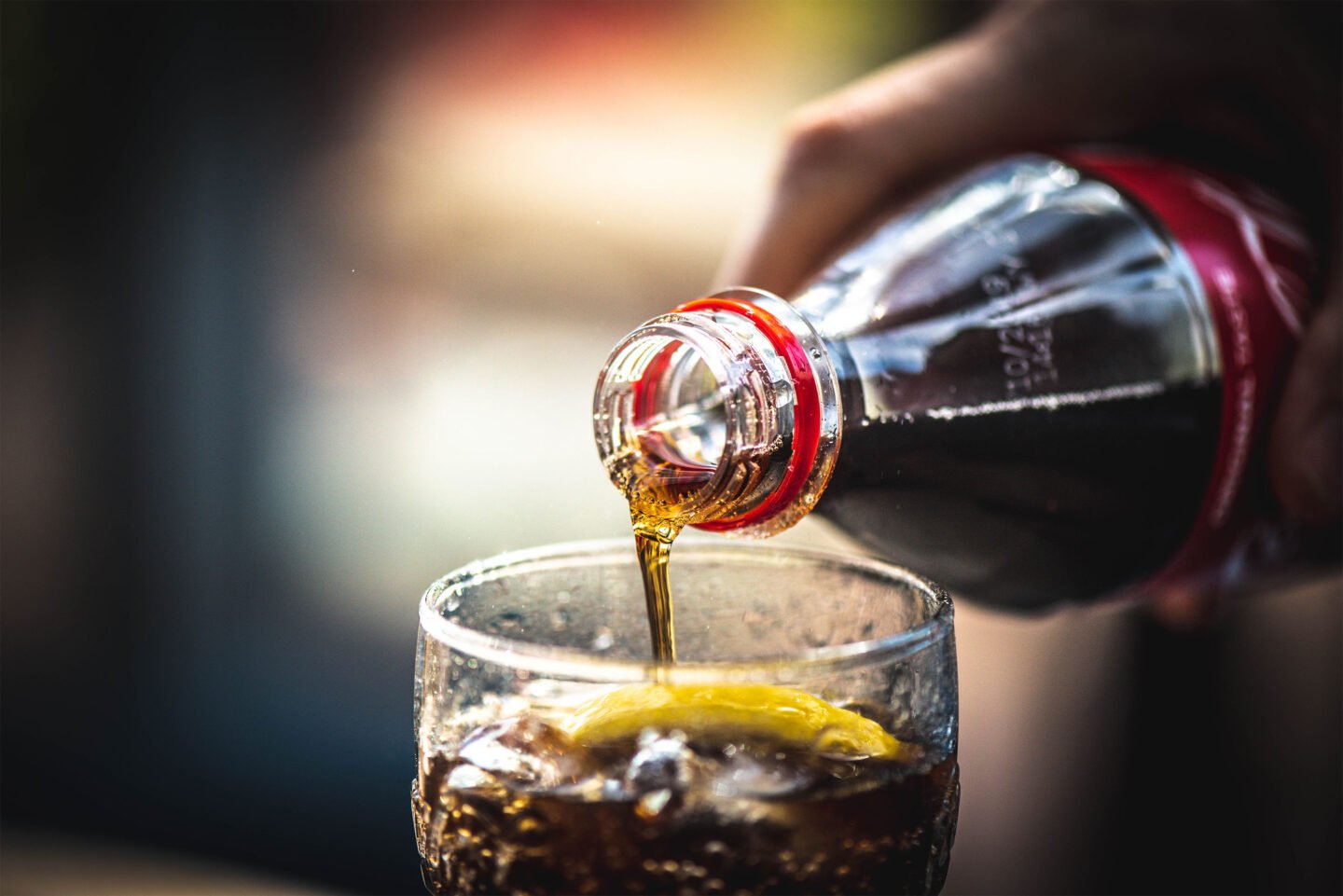 pouring coca cola into glass