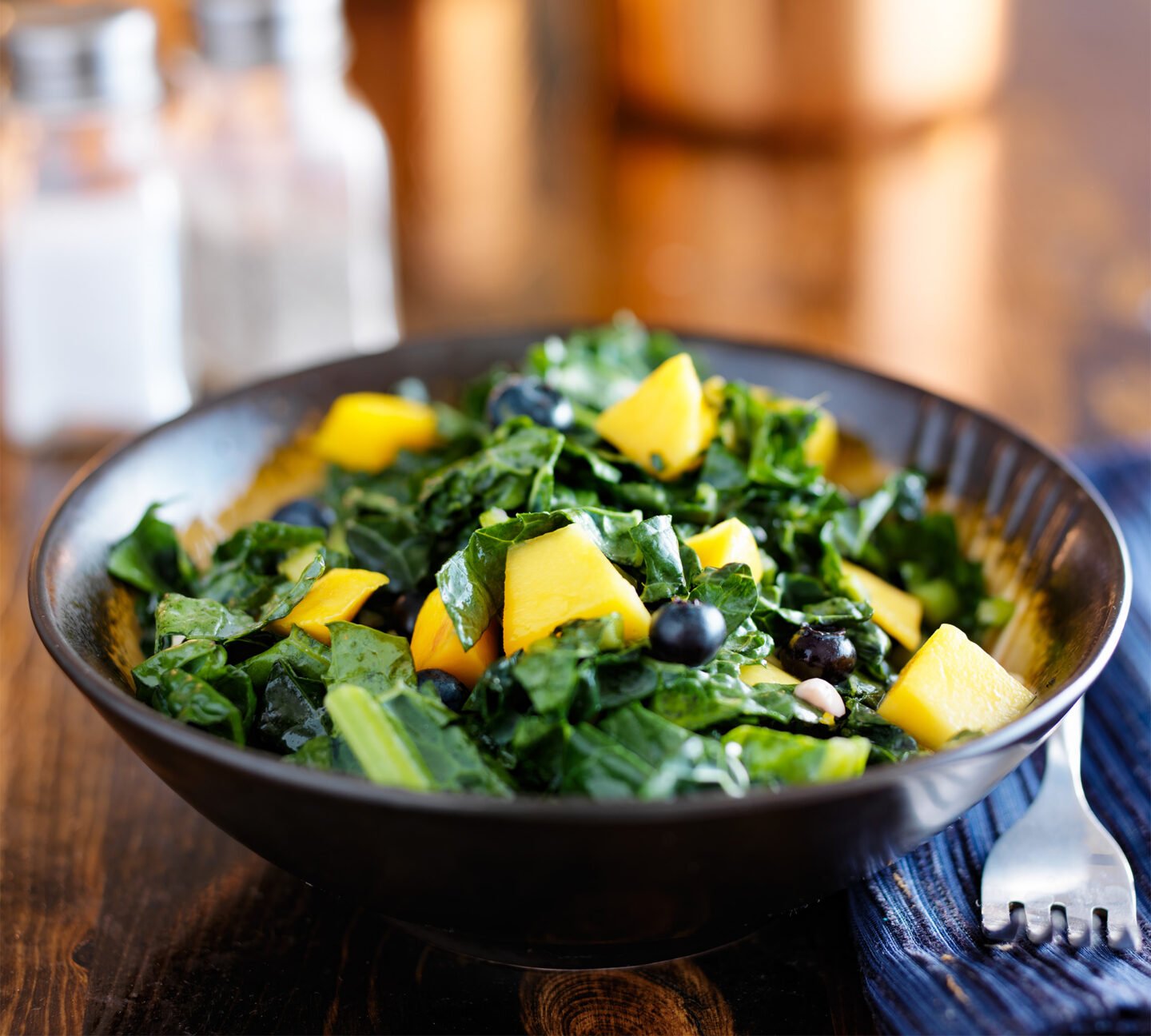 bowl of healthy blueberry mango and kale salad
