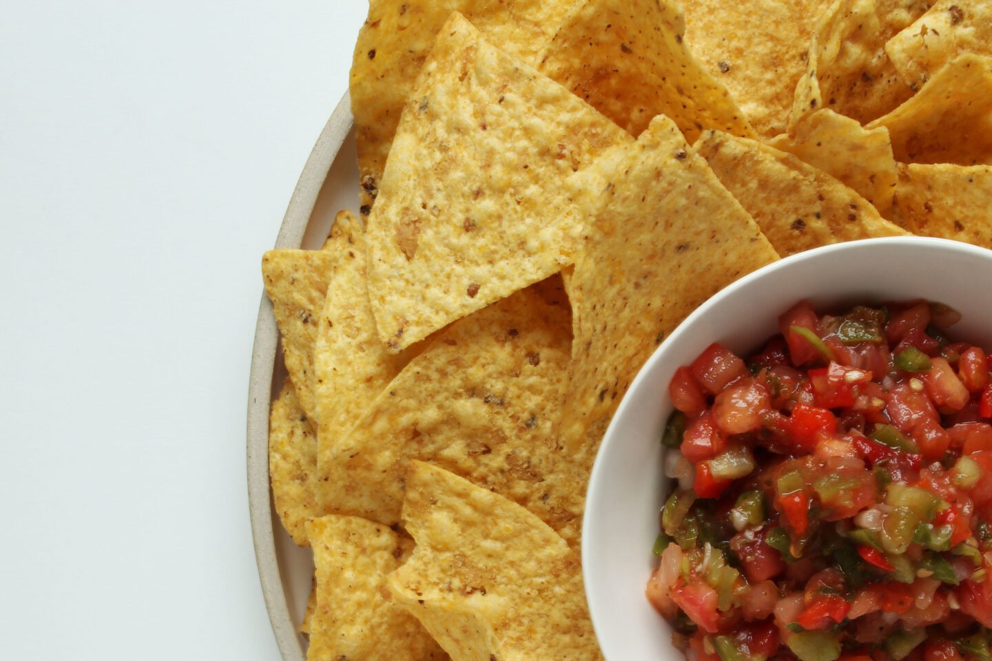 plate of yellow corn tortilla chips with salsa
