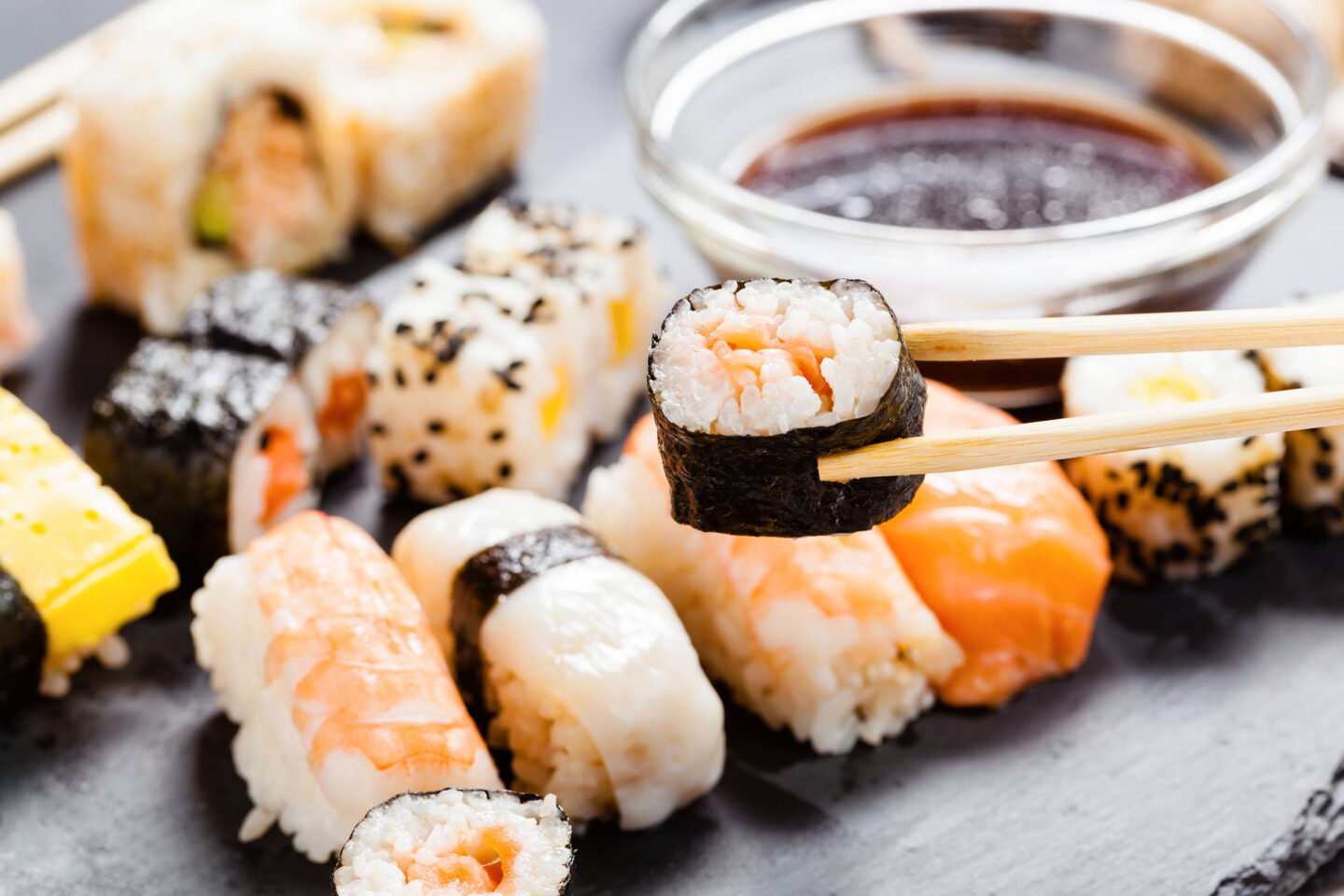 slate tray of assorted sushi