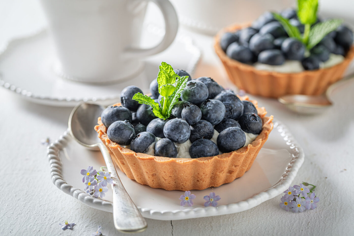 tasty mini tart with blueberries and cream