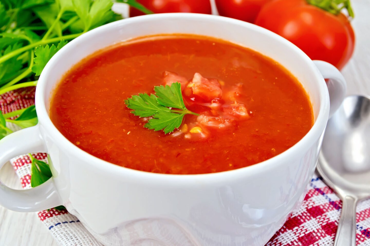 tomato soup with spoon on napkin