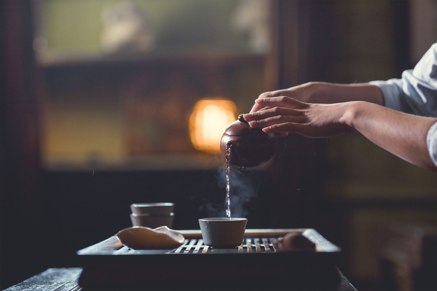 woman pouring tea from teapot