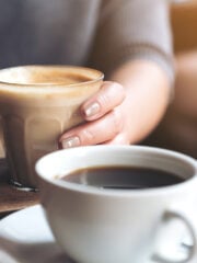americano coffee cup and woman holding a cup of latte