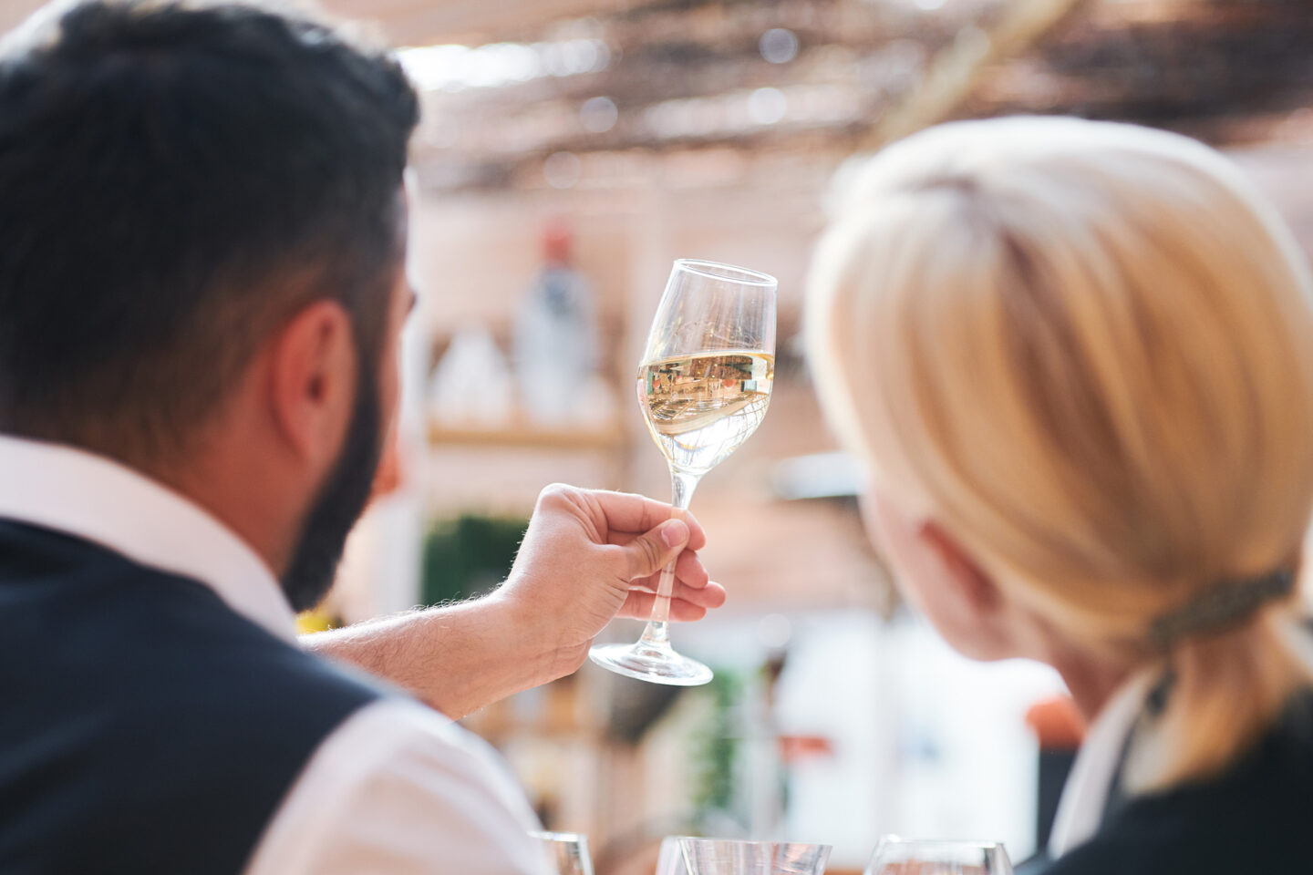 two professional sommeliers studying white wine