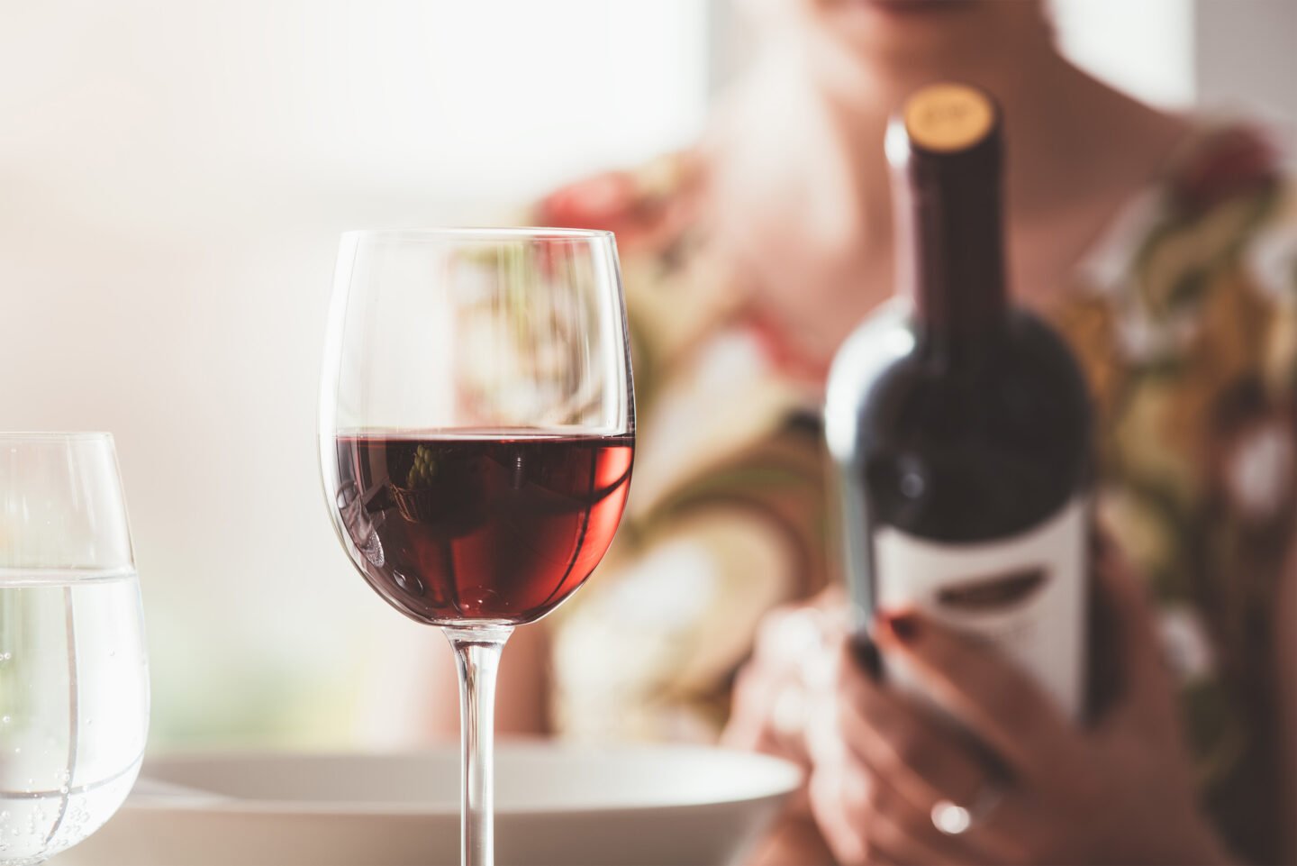 woman reading a wine label