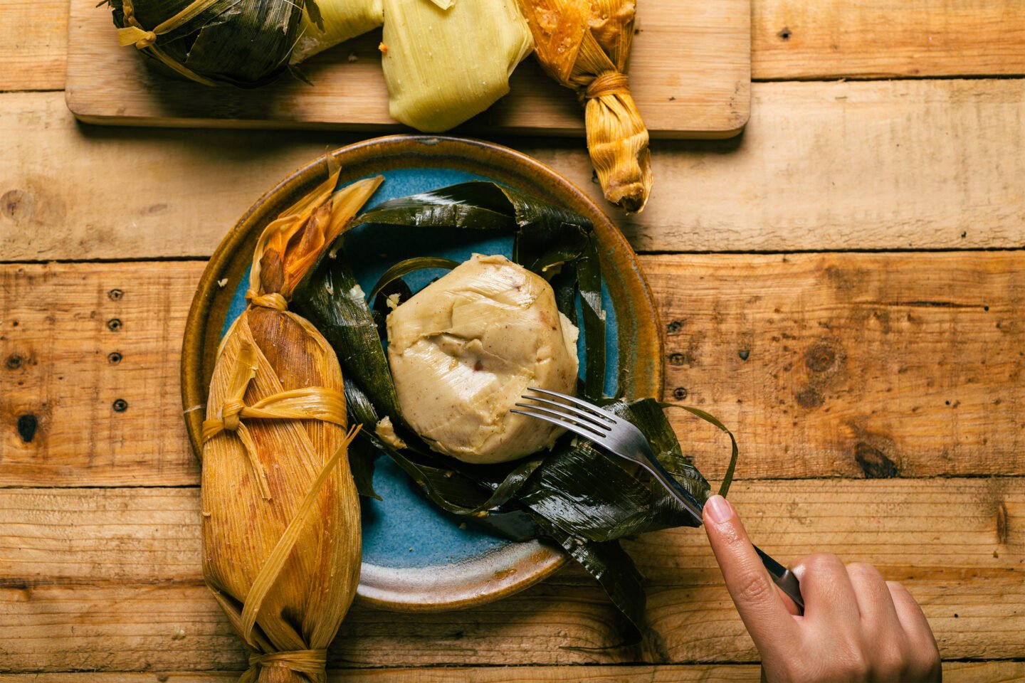 cutting a tamale with a fork