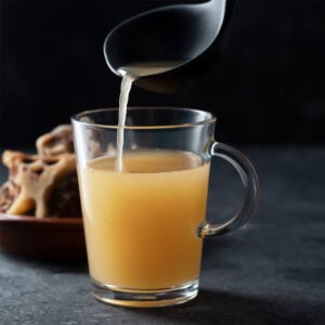 homemade beef bone broth in glass storage jar