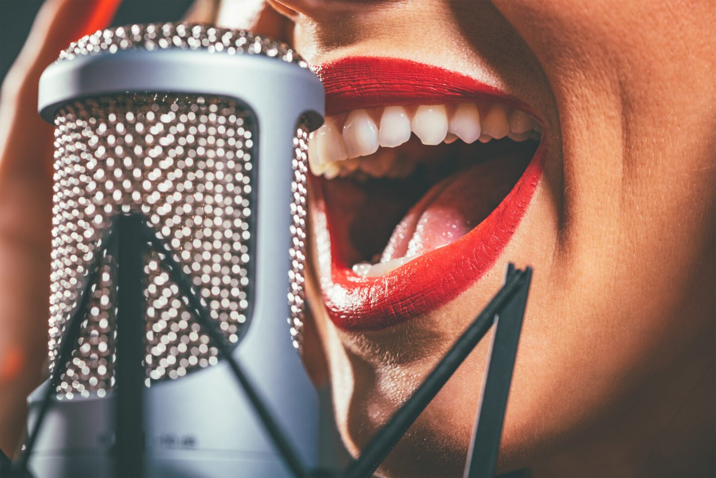 woman singing close to filtered microphone