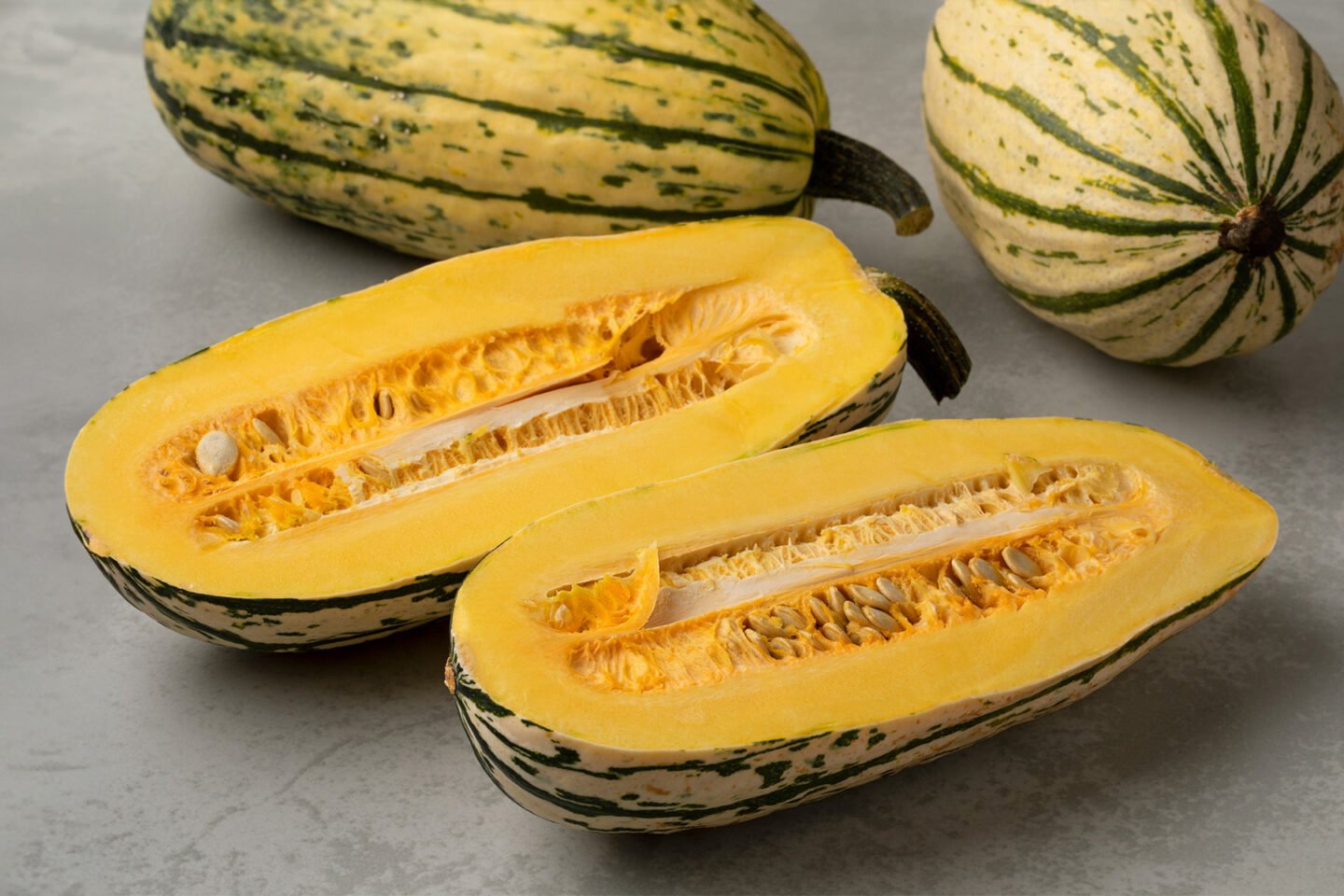 delicata pumpkins whole and halved ones