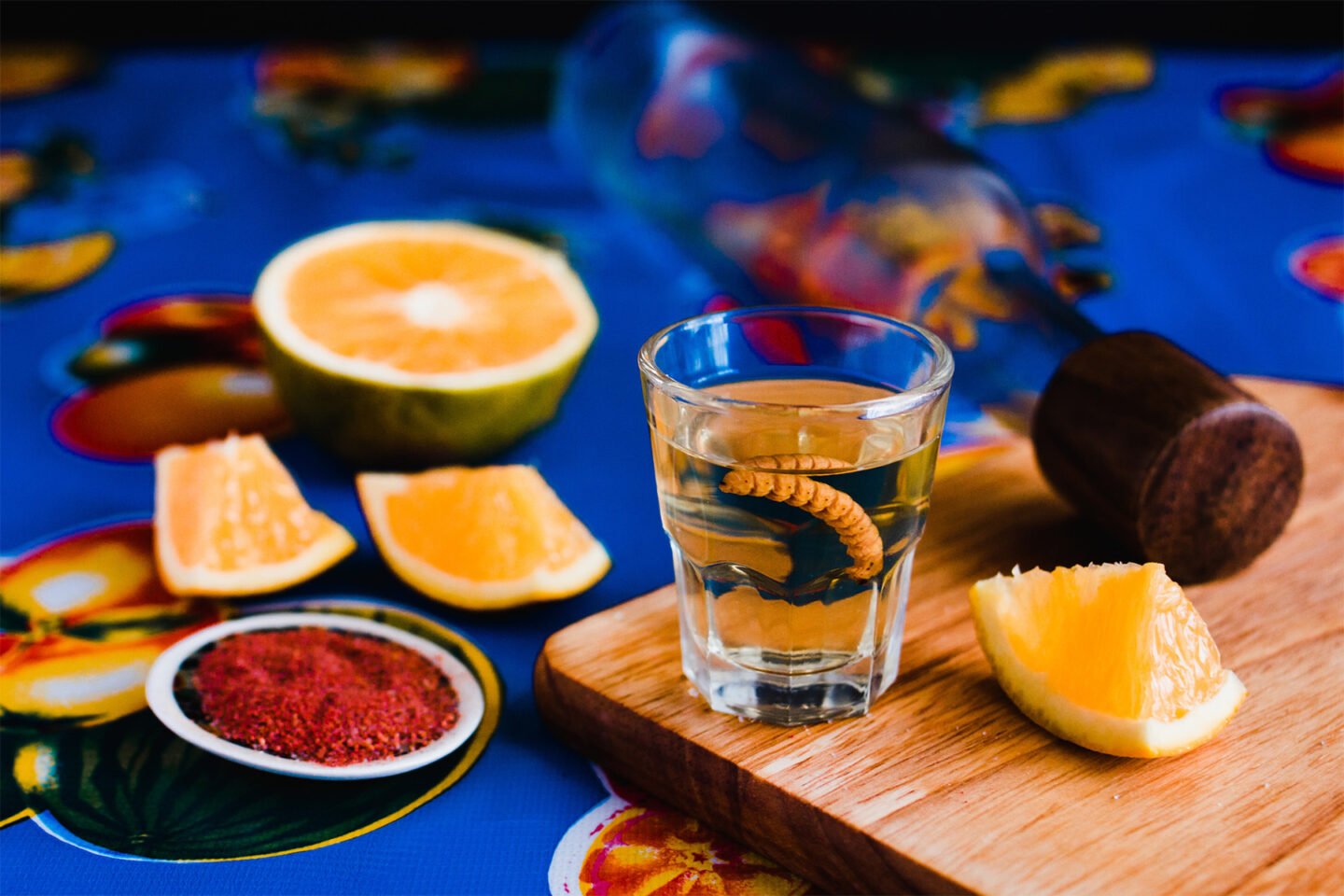 mezcal shot with agave worm chili salt and orange slices