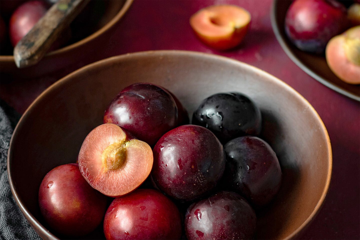red plums in a bowl